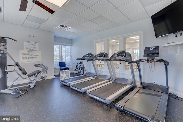 gym with a drop ceiling and ceiling fan