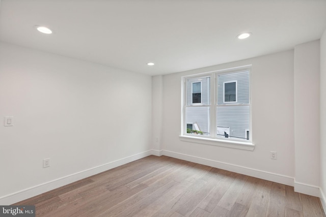 unfurnished room with light hardwood / wood-style flooring