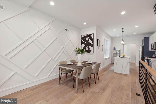 dining room featuring light hardwood / wood-style floors