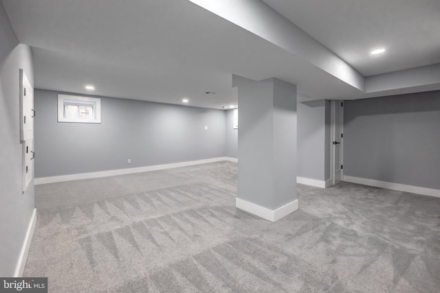 basement featuring light colored carpet