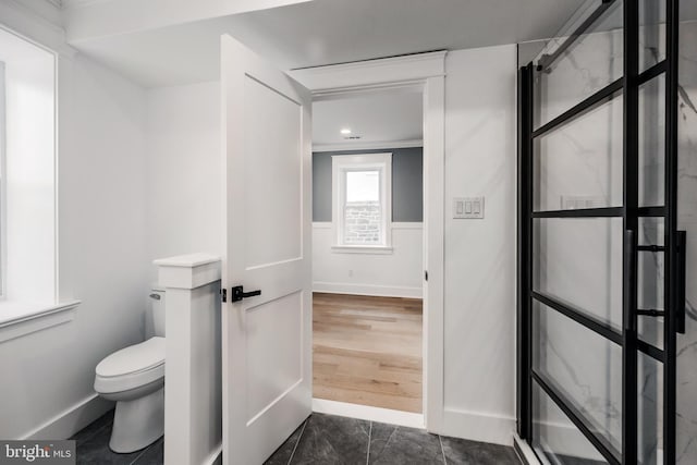 bathroom featuring toilet and hardwood / wood-style flooring