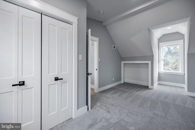 bonus room with light carpet and lofted ceiling