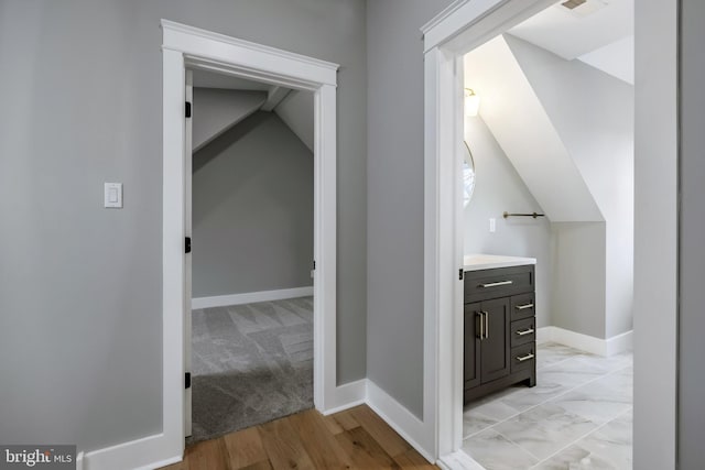 interior space with vaulted ceiling and light hardwood / wood-style flooring