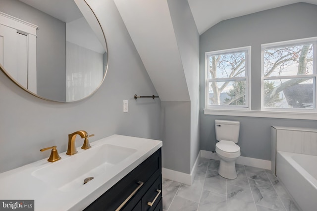 bathroom featuring a bathing tub, vanity, lofted ceiling, and toilet