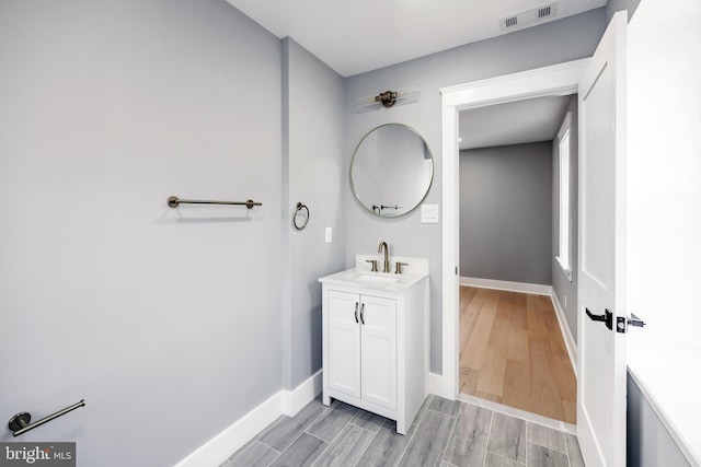 bathroom with hardwood / wood-style floors and vanity