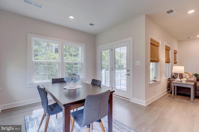 dining space with wood-type flooring