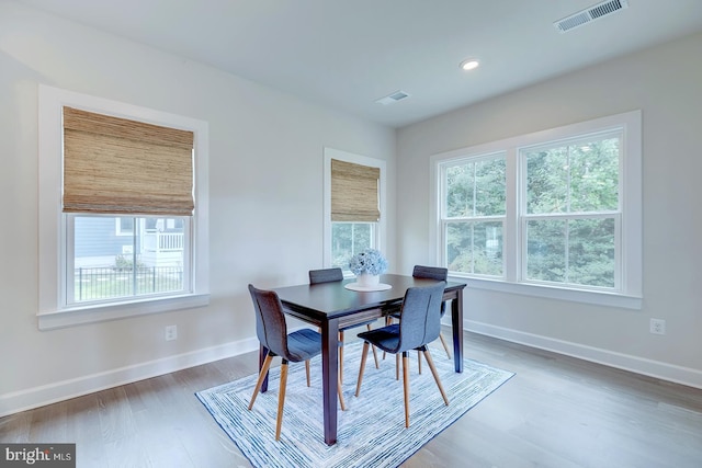 dining space with wood-type flooring