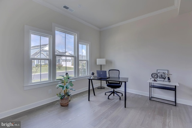 office area with ornamental molding and light hardwood / wood-style flooring