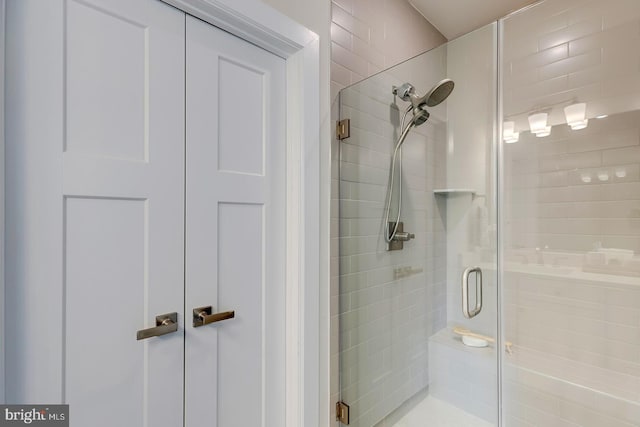 bathroom featuring a shower with door