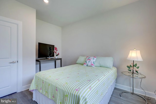 bedroom with dark hardwood / wood-style flooring