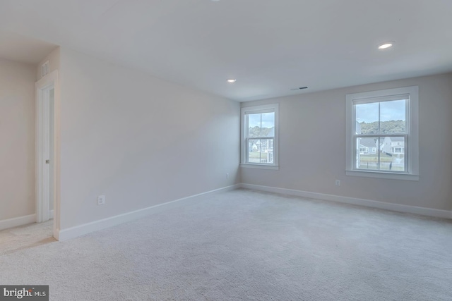 carpeted empty room with a wealth of natural light