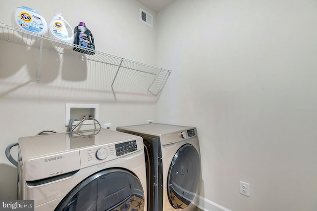 laundry room with independent washer and dryer