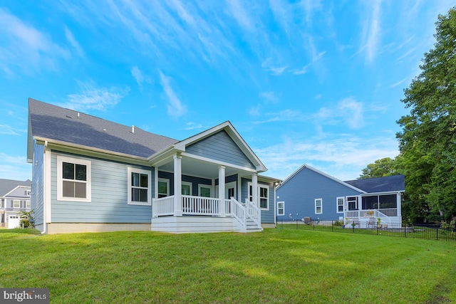 back of property featuring a yard and a porch