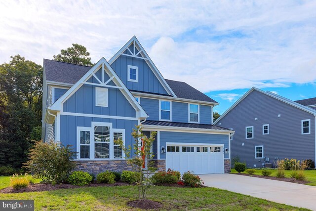 craftsman-style house featuring a front yard and a garage