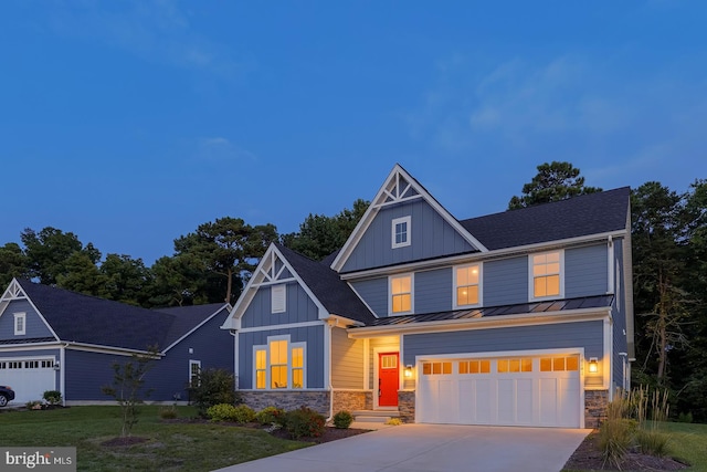 view of front of property with a front yard and a garage