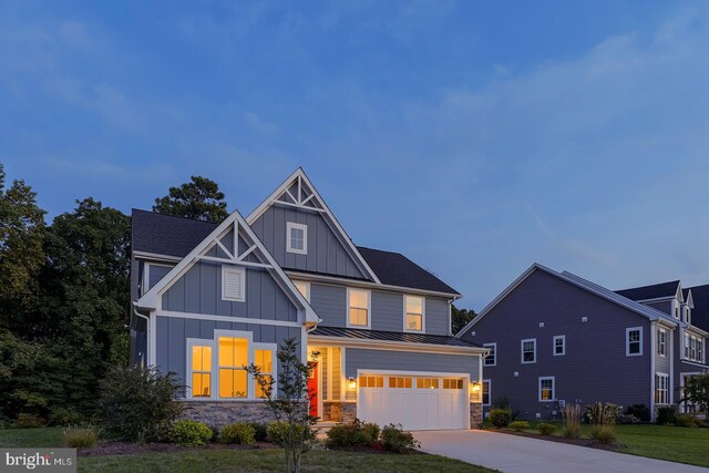 view of front of home with a front yard and a garage