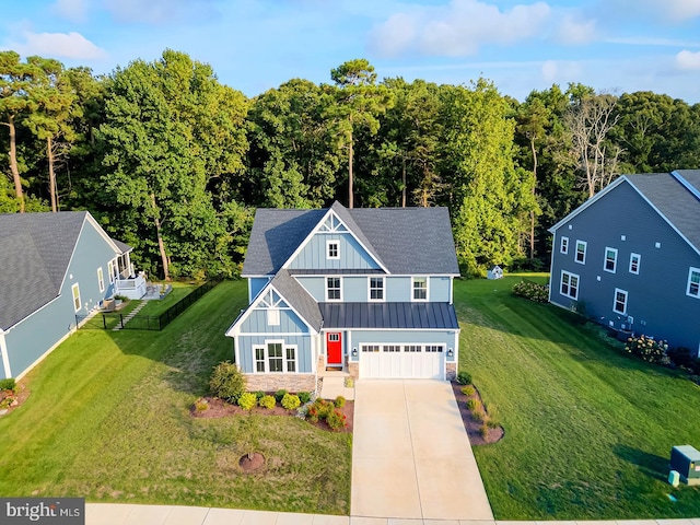 view of front of property featuring a garage and a front lawn