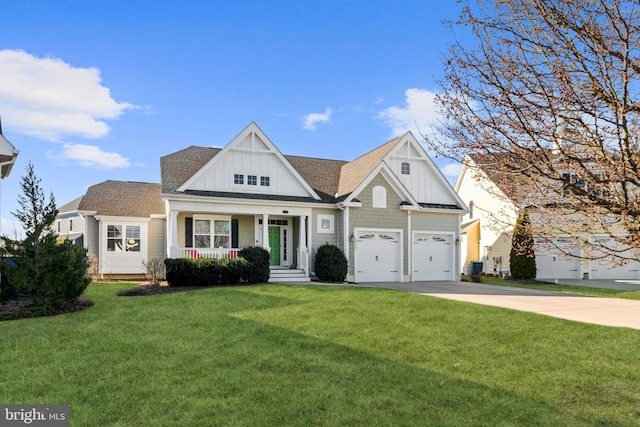 view of front of house with a garage, a front lawn, and covered porch