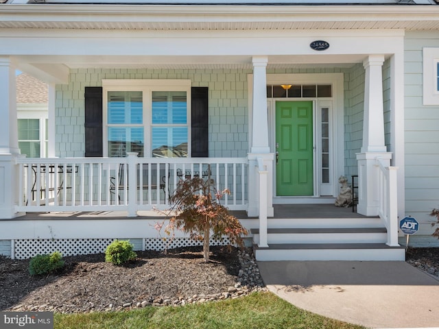 doorway to property featuring a porch