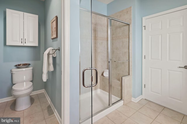 bathroom with an enclosed shower, toilet, and tile patterned floors