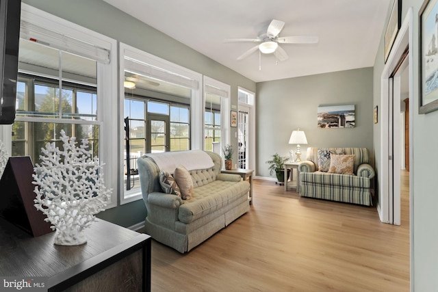 living room featuring ceiling fan and light wood-type flooring