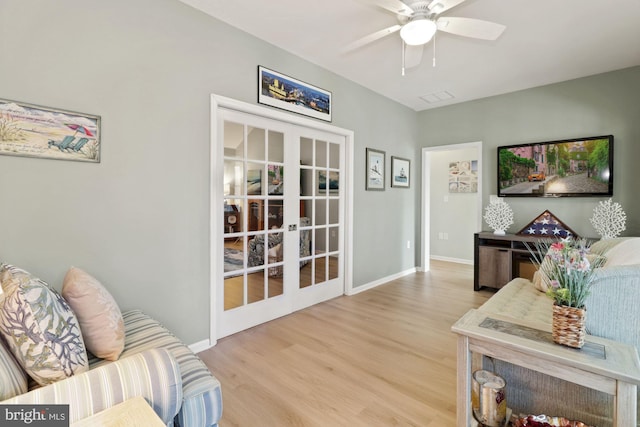 living room with french doors, light hardwood / wood-style flooring, and ceiling fan