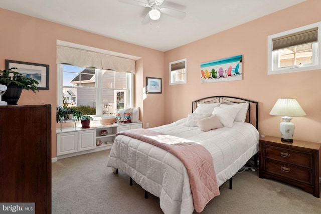 bedroom featuring ceiling fan and light carpet