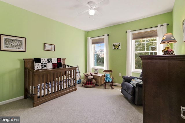 bedroom featuring light colored carpet and ceiling fan