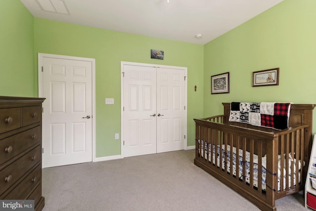 bedroom featuring carpet, a nursery area, and a closet