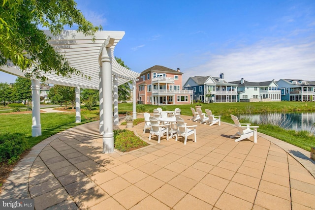 view of patio / terrace featuring a balcony, a pergola, and a water view