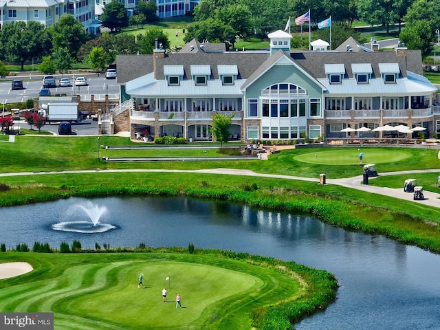 birds eye view of property with a water view and view of golf course