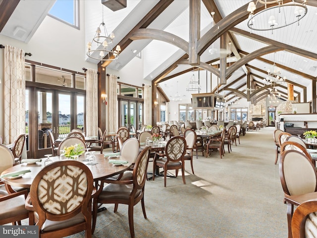 dining room featuring carpet, high vaulted ceiling, an inviting chandelier, beam ceiling, and french doors