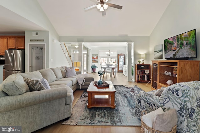 living room featuring lofted ceiling, ceiling fan, decorative columns, and light hardwood / wood-style floors