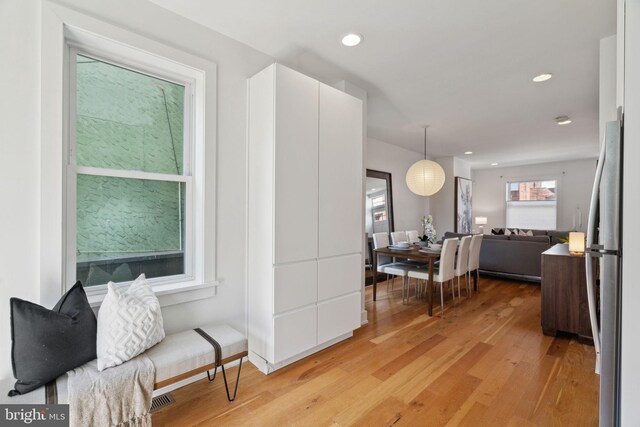 kitchen featuring white cabinets, stainless steel appliances, and light hardwood / wood-style floors