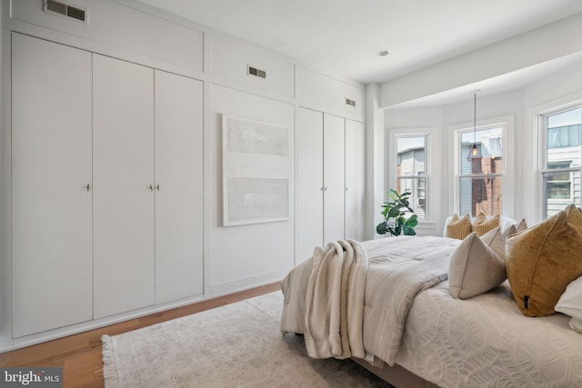 bedroom with hardwood / wood-style flooring