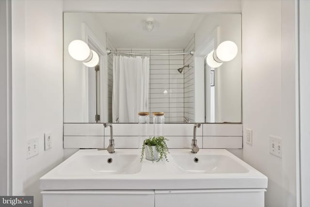 bathroom with walk in shower and vanity