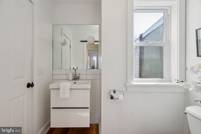 bathroom featuring vanity, toilet, and wood-type flooring