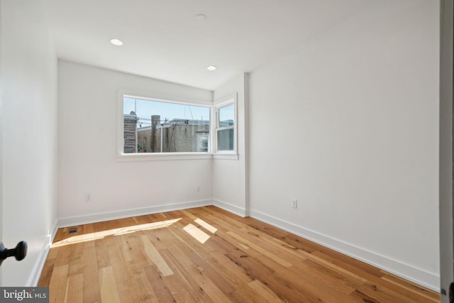 spare room with hardwood / wood-style floors