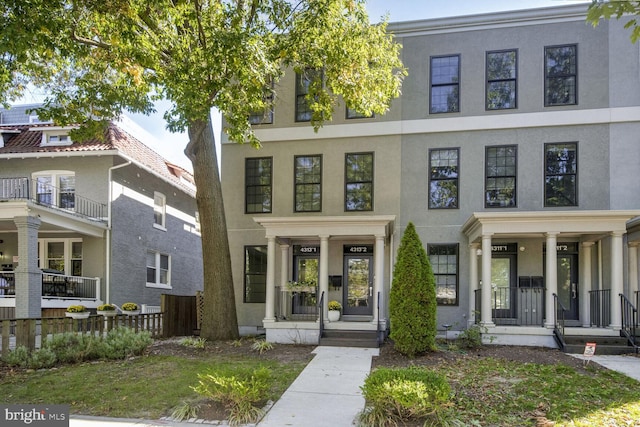 view of front of property with a porch and a balcony