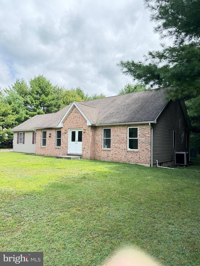 single story home featuring a front lawn and cooling unit