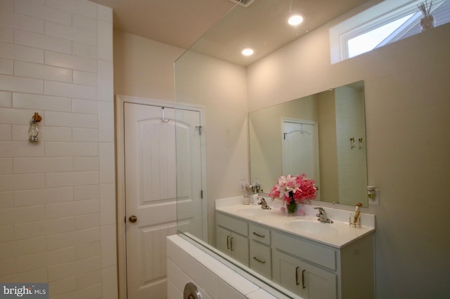 full bath with recessed lighting, a sink, and double vanity