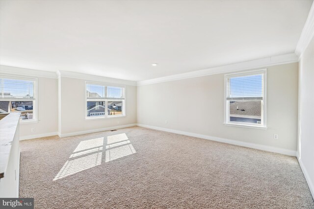 empty room with baseboards, visible vents, and light colored carpet