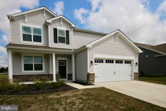 view of front of home featuring a garage, stone siding, and driveway