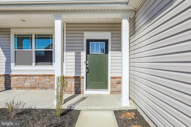 entryway featuring dark wood-type flooring, french doors, a healthy amount of sunlight, and crown molding