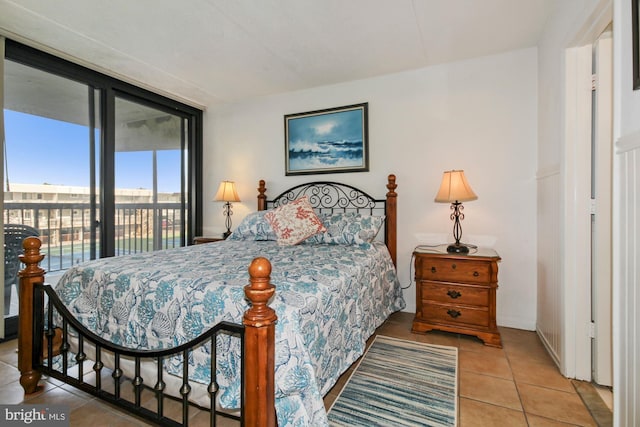 bedroom featuring access to exterior and light tile patterned flooring