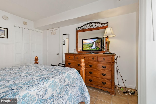 tiled bedroom with a closet