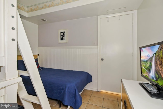 bedroom featuring light tile patterned floors