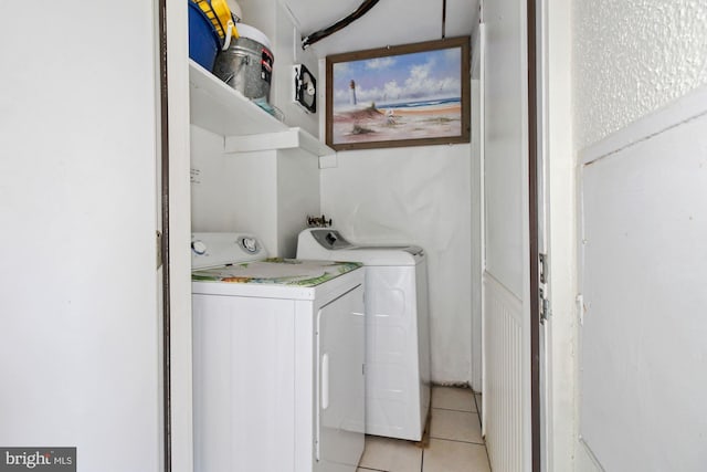 washroom featuring washer and dryer and light tile patterned floors