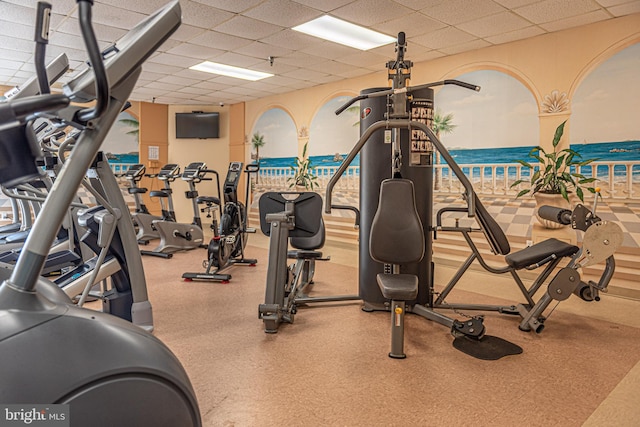 workout area with a paneled ceiling