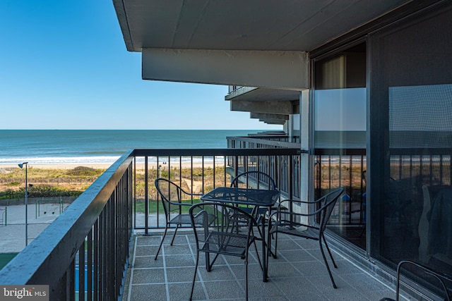 balcony with a beach view and a water view